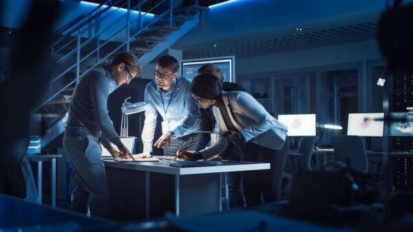 nighttime workers hunched over workbench