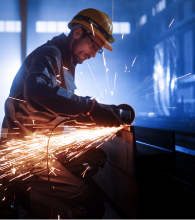 metal worker using buzzsaw on beam