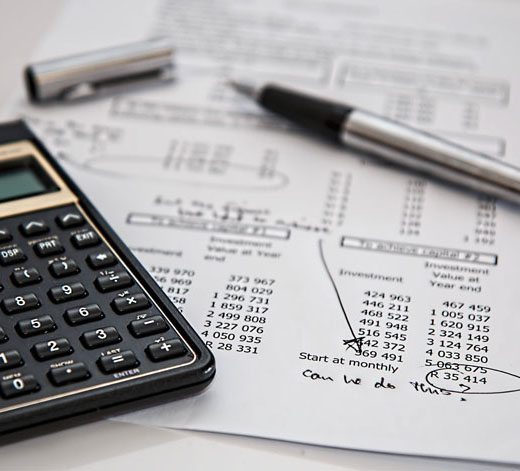 annotated invoice with pen and calculator