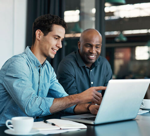 Teamwork, diversity and sales manager planning branding ideas with a creative designer on a laptop in an office. Logo, collaboration and businessman talking to an employee about a development project