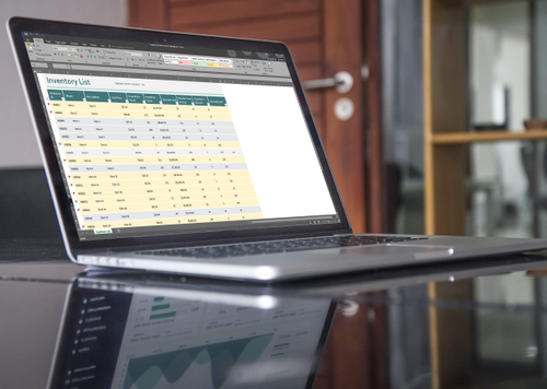 laptop on conference table displaying an inventory list