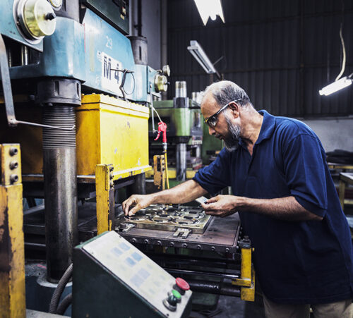 Hard working factory employee completing his tasks.