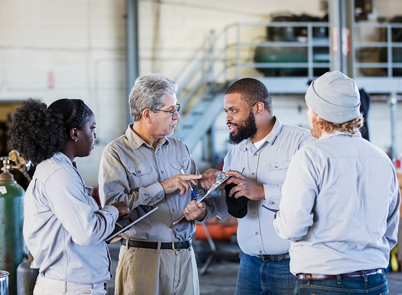 Project Management team discusses software in a manufacturing shop
