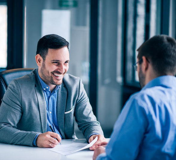 sales meeting two men sitting across from each other