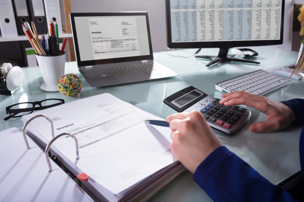 Businessperson Calculating Invoice