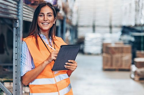 female warehouse worker smiling in frame