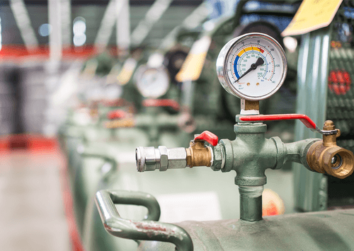 pv tanks in factory with pressure dial in focus