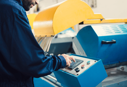 CNC machine operator using control panel