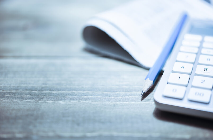 Office supply. Pile of papers paperwork on wooden office desk table. Blue tinted image. Background with copy space.