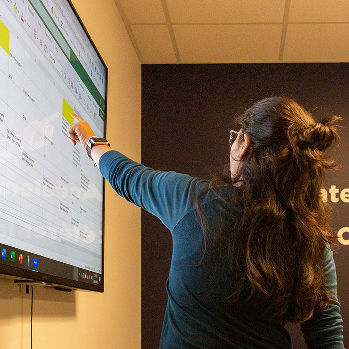 marketing meeting presenter pointing to screen