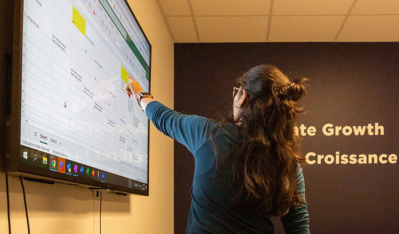 marketing meeting presenter pointing to screen