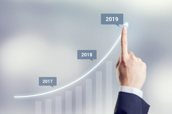 Growth in 2019 year concept. Hand of businessman plan growth and increase of positive indicators in his business.