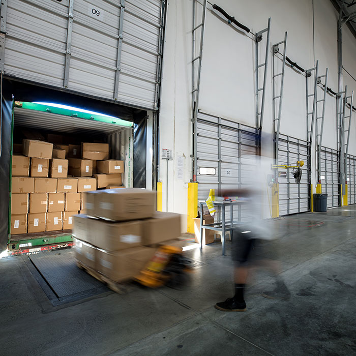 Worker Unloading Truck at Warehouse Loading Dock