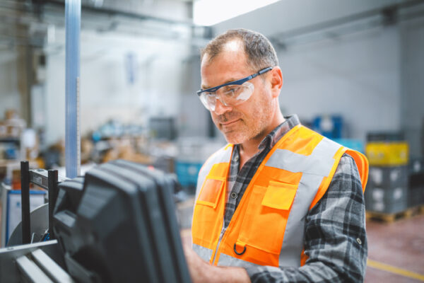 man with glasses looking at screen